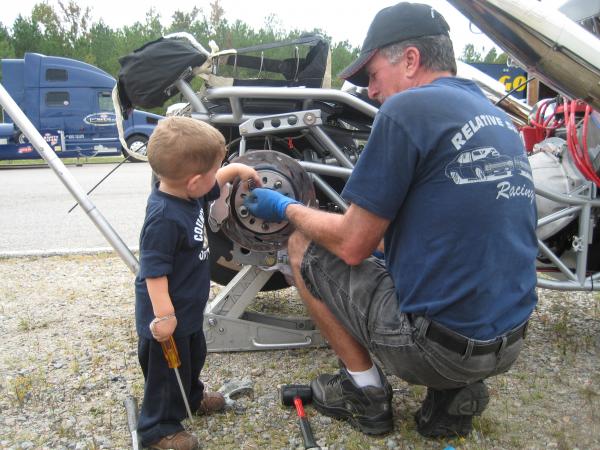 Tyler helping Grandpa with the Brakes......Is this a good idea?