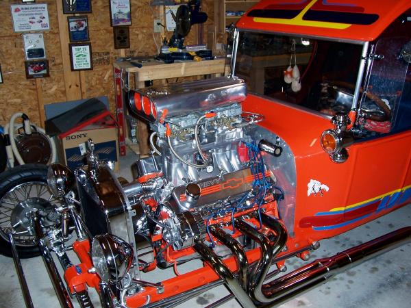 100 0034 The engine has been bored 30 with a 292 comp cam and roller rockers. Gear drive timing as well as high flow oil pump and 10 qt pan. MSD ignition. High rise has two 600 Holleys rebuilt with Berry Grant parts. The headers on it now are made of 2" pipe (sprint style like these)